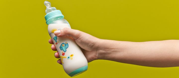 Hand haelt Babyflasche