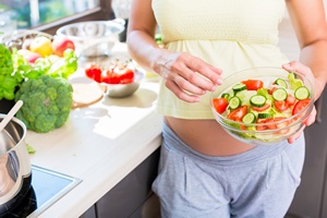 Schwangere hält Salat